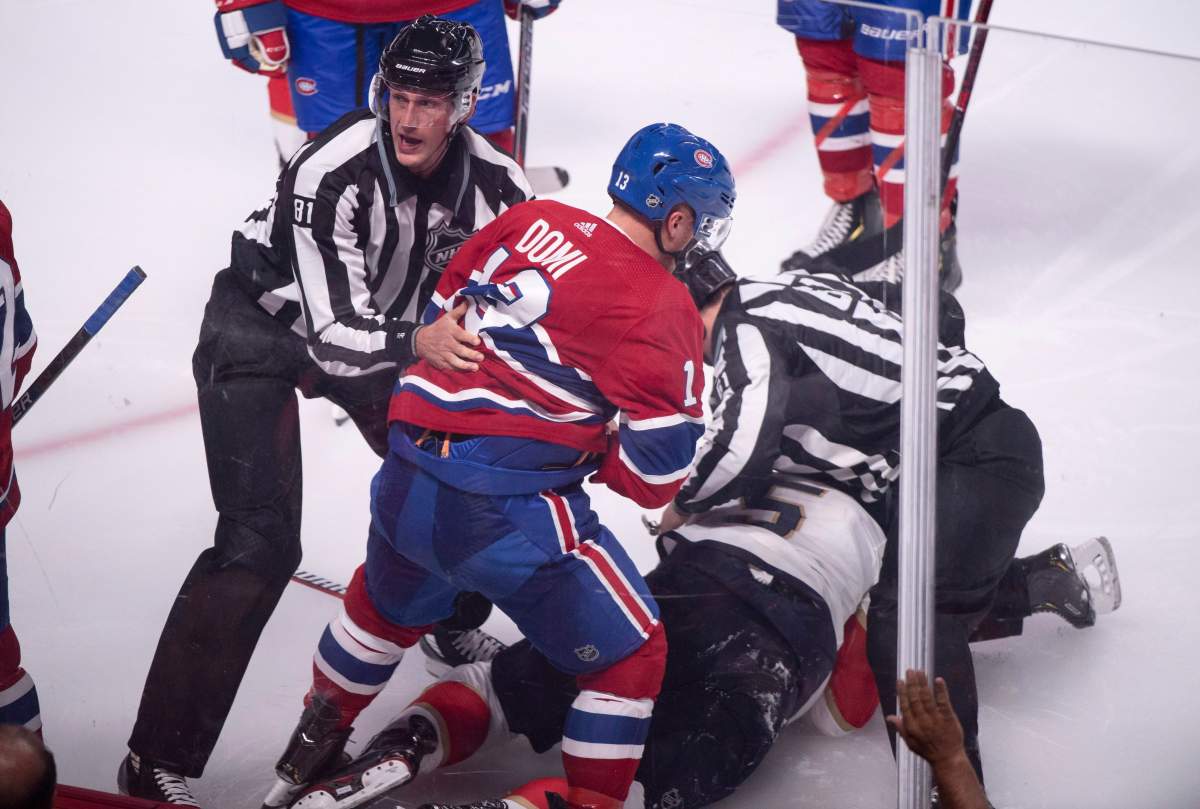 Montreal Canadiens' Max Domi is pulled away by linesman Ryan Daisy after a brief fight with Florida Panthers' Aaron Ekblad during third period NHL hockey action in Montreal on Wednesday, September 19, 2018.
