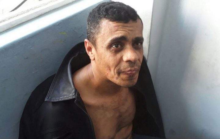 In this photo released by the Military Police, Adelio Bispo de Oliveira, suspected of stabbing Jair Bolsonaro, a leading Brazilian presidential candidate, sits after being detained in Juiz de Fora, Brazil, Thursday, Sept. 6, 2018.
