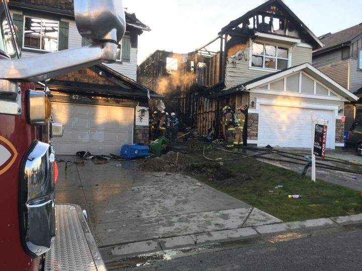 A two-alarm fire on Panamount Common N.W. in the Calgary community of Panorama Hills severely damaged two homes and caused minor damage to a third on Sept. 5, 2018.