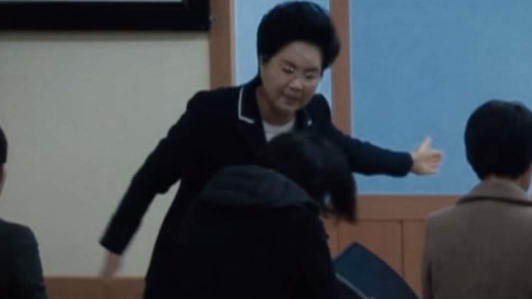 Ok-Joo Shin, head pastor of the Grace Road Church, is shown striking a person in this image from video published by SBS in South Korea.