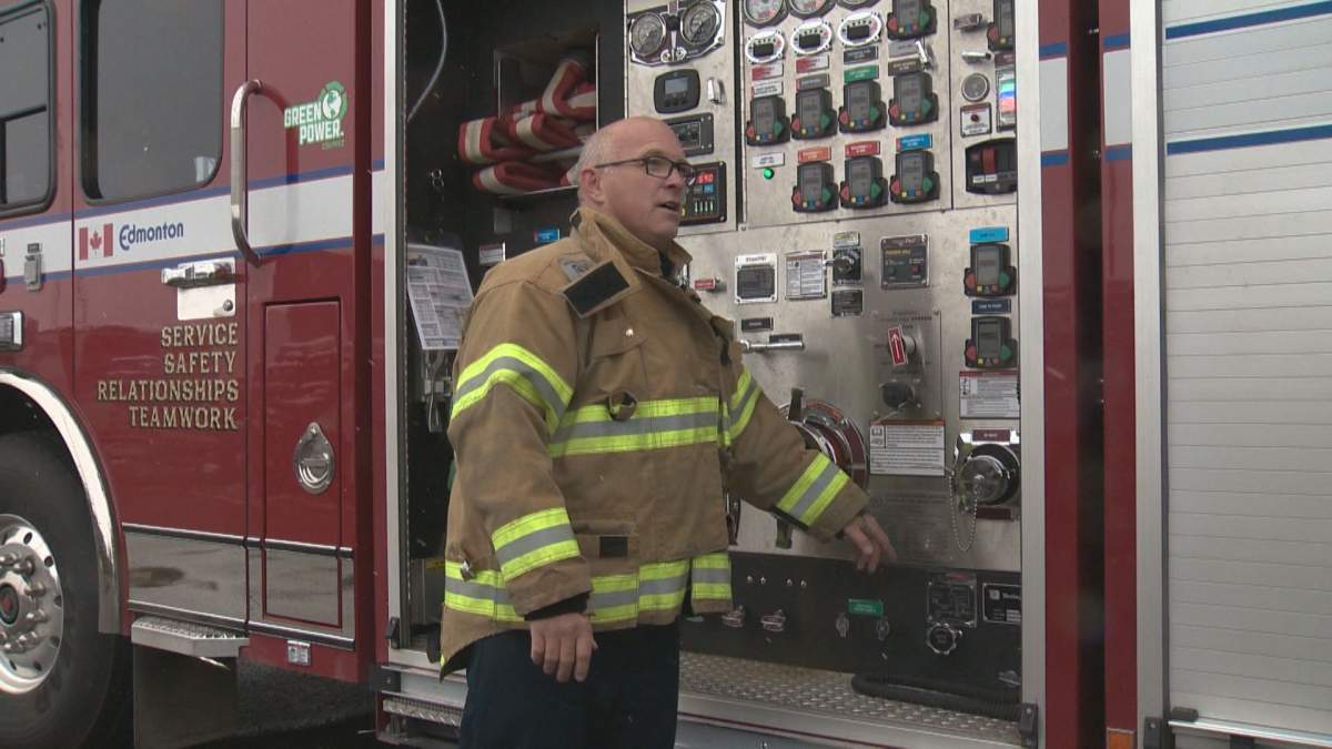 Chris McDonald shows off one of the city’s new pump trucks which can get water more than 80 stories up to firefighters.