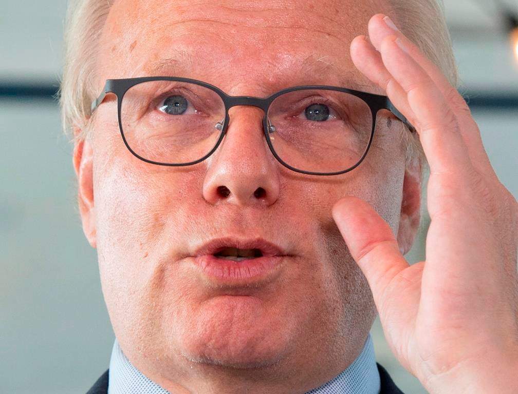 PQ leader Jean-François Lisée adjust his glasses as he speaks to the media while campaigning.