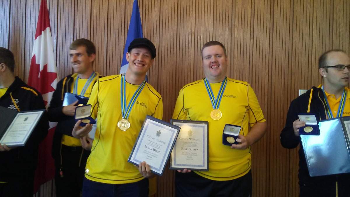 Special Olympics Manitoba athlete Dave Friesen, right, shows off his gold medal won at the 2018 Special Olympics Canada Summer Games.