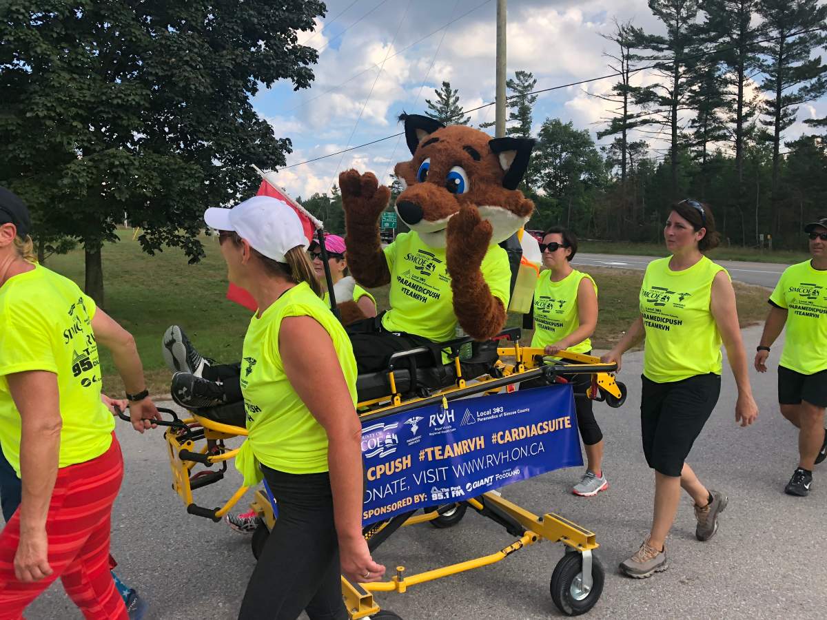Simcoe County paramedics who walked more than 30 kilometres from Stayner to Midhurst make the final turn on their journey.