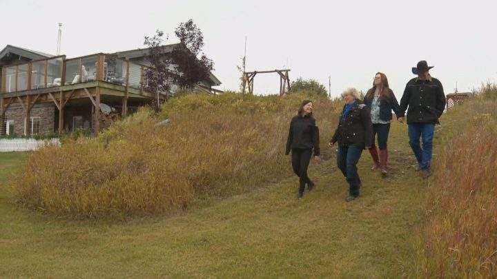 “Even if a couple generations from now, kids choose to sell it, it will still have a conservation easement on it, which means it is part of our natural heritage as Albertans,” said Environment Minister Shannon Phillips. She’s pictured left with WineGlass Ranch owner Edith Wearmouth and her family.