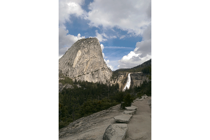 In this March 28, 2016 file photo provided by the National Park Service, water flows over the Nevada Fall near Liberty Cap as seen from the John Muir Trail in Yosemite National Park, Calif.