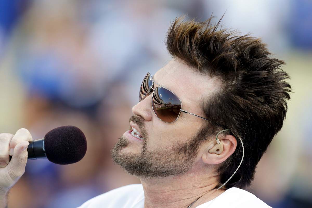 Singer Billy Ray Cyrus performs the national anthem before a baseball game between the Los Angeles Dodgers and the Cincinnati Reds in Los Angeles, Wednesday, July 4, 2012.