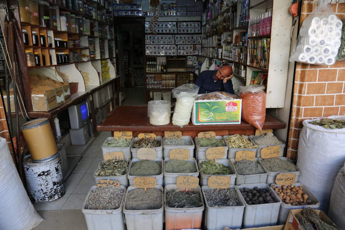 A shopkeeper naps amid his spices in Qamlishi, in Kurdish-controlled northeast Syria.