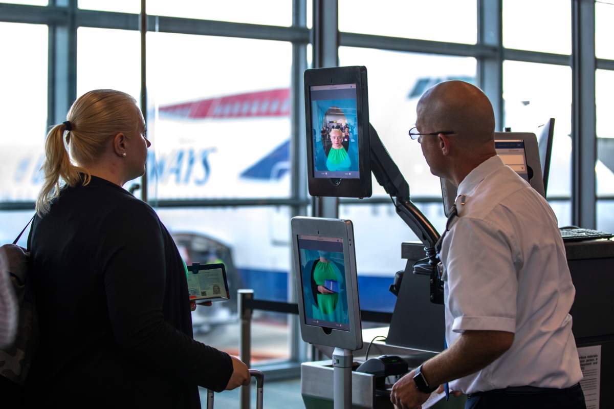 Passengers boarding a Scandinavian Airlines flight to Copenhagen use an airport-wide biometric facial recognition terminal at Dulles International Airport in Dulles, Virginia.