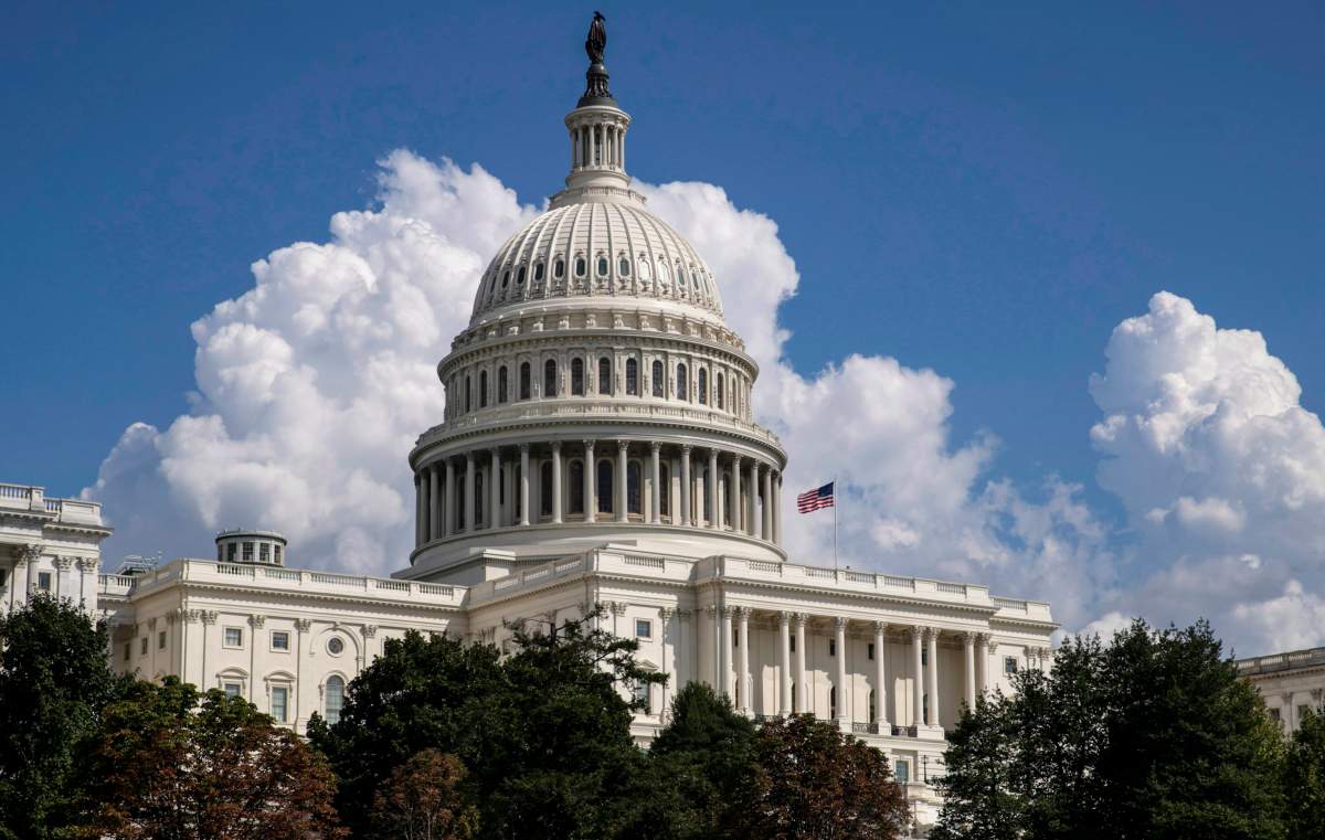 FILE- In this Sept. 3, 2018, file photo an American flag flies on the U.S. Capitol in Washington.