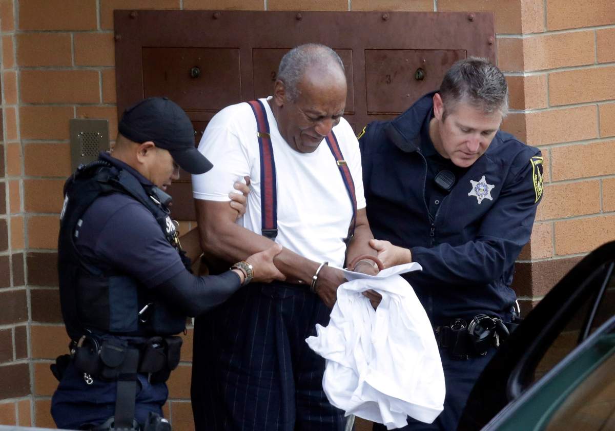 In this Sept. 25, 2018 file photo, Bill Cosby is escorted out of the Montgomery County Correctional Facility in Eagleville, Pa., following his sentencing.