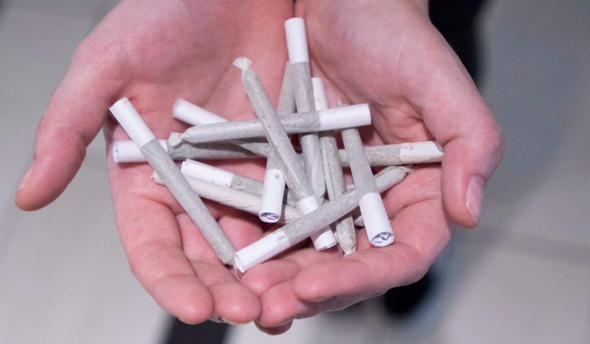 A employee holds pre-rolled joints at Buddha Barn Craft Cannabis in Vancouver, Tuesday, Oct. 2, 2018. 