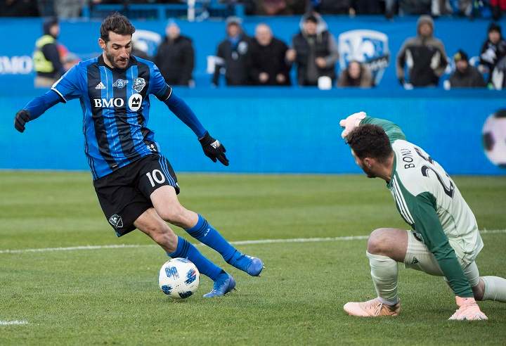 Montreal Impact's Ignacio Piatti moves in on Toronto FC's goalkeeper Alexander Bono during second half MLS soccer action in Montreal, Sunday, October 21, 2018. 