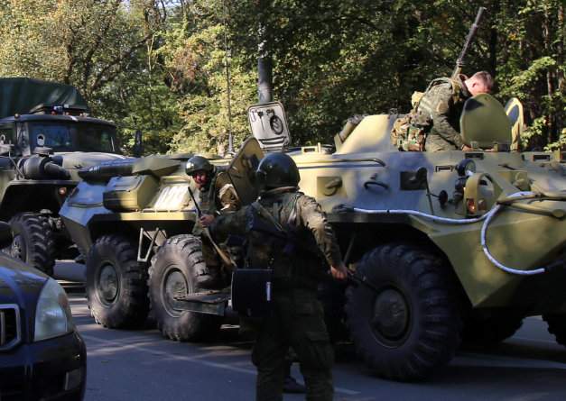 Law enforcement officers gather at the scene of a fatal attack on a college in the port city of Kerch, Crimea October 17, 2018.
