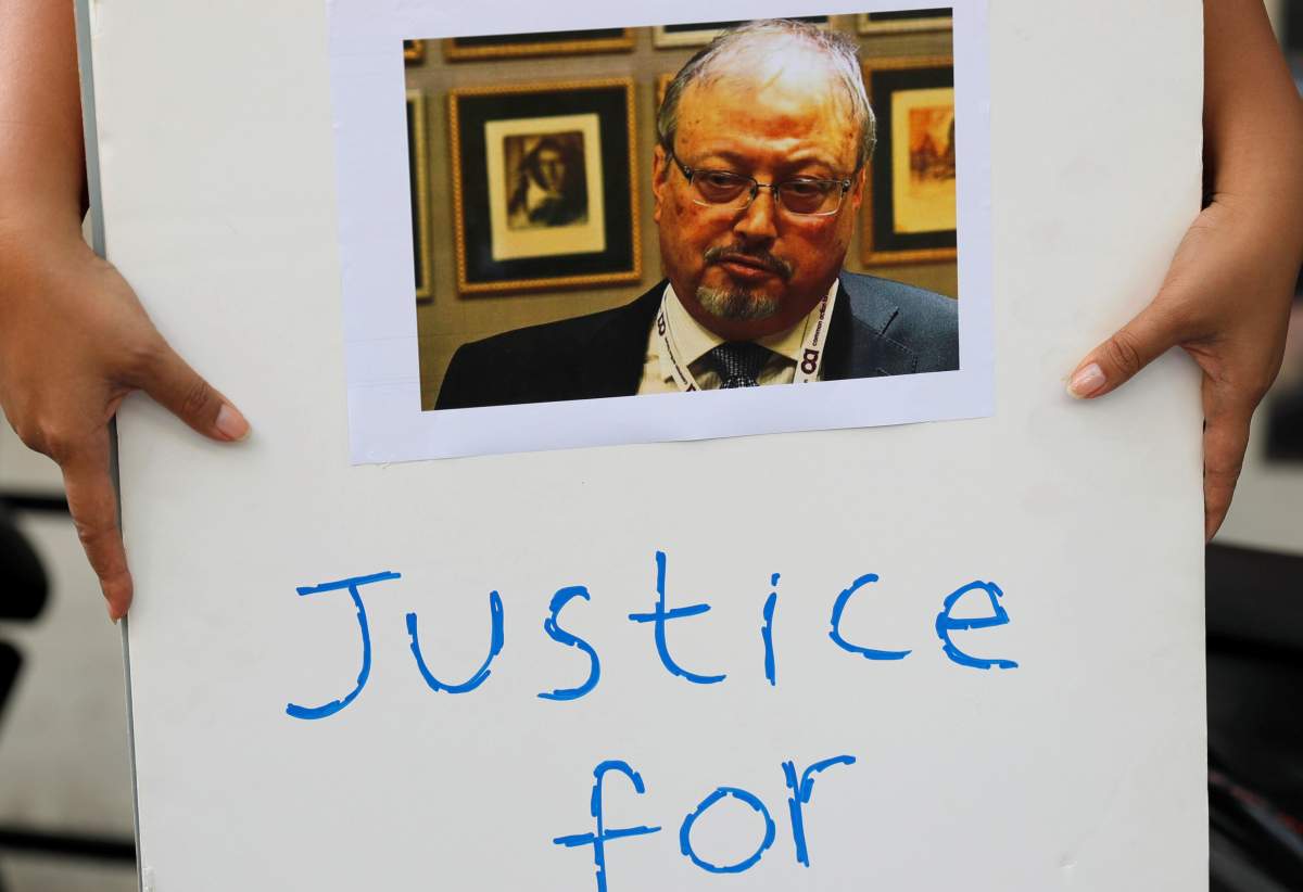 An Indonesian journalist holds a placard during a protest over the disappearance of Saudi journalist Jamal Khashoggi in front of the Saudi Arabia embassy in Jakarta, Indonesia, October 19, 2018. 