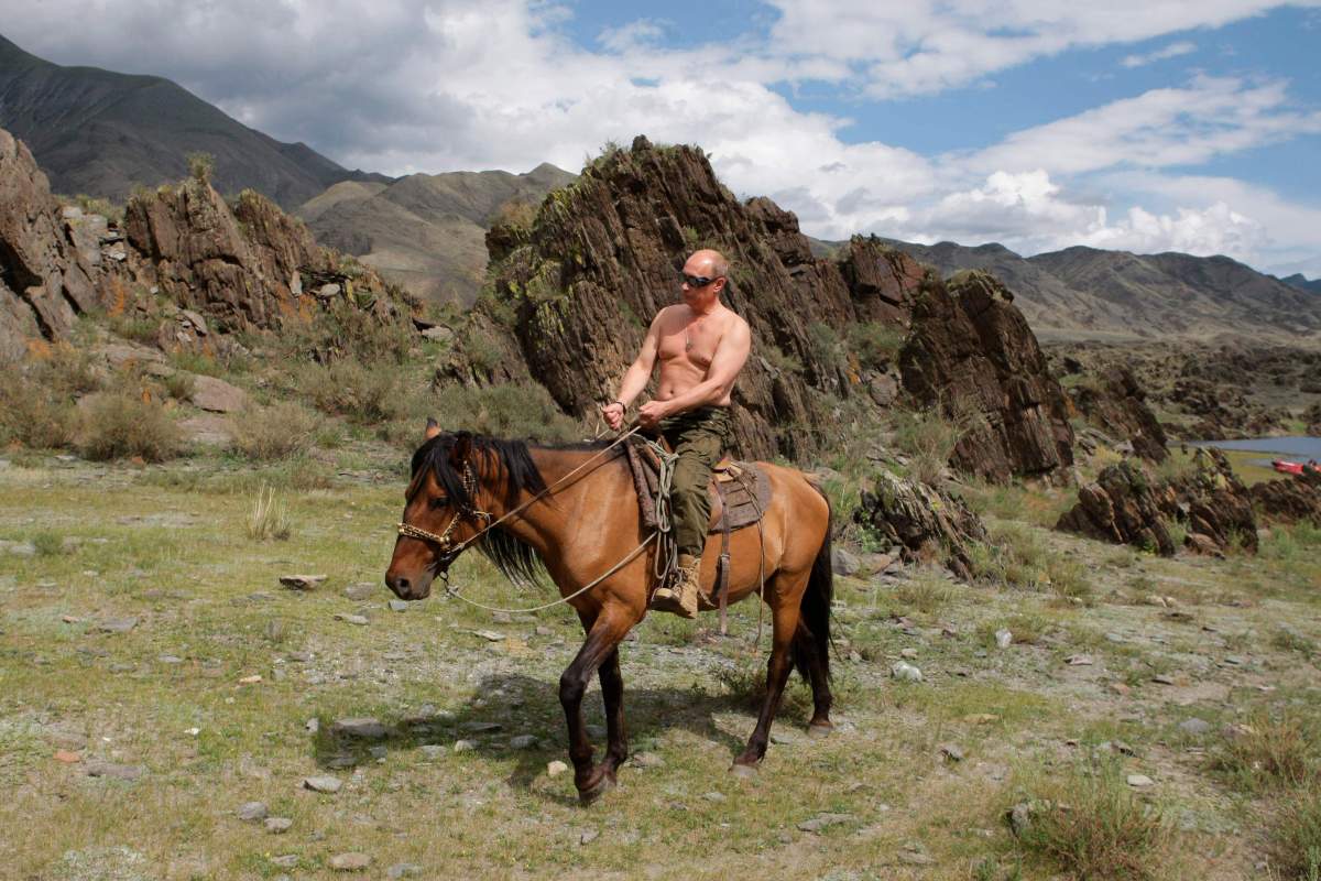 In this photo taken on Monday, Aug. 3, 2009, Russian Prime Minister Vladimir Putin seen riding a horse in the mountains of the Siberian Tyva region (also referred to as Tuva), Russia, during his short vacation.