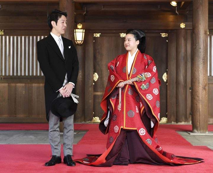Japanese Princess Ayako, right, dressed in traditional ceremonial robe, and groom Kei Moriya, left, speak to the reporters after their wedding ceremony at Meiji Shrine in Tokyo, Monday, Oct. 29, 2018.
