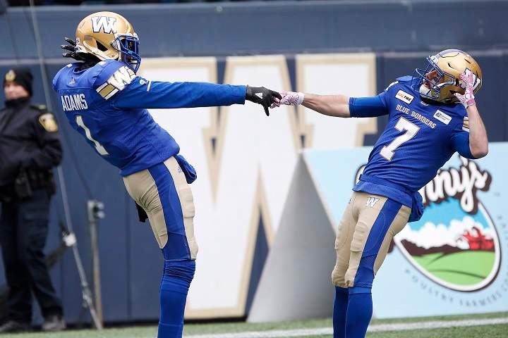 Winnipeg Blue Bombers' Darvin Adams (1) and Weston Dressler (7) celebrate Adams' touchdown against the Saskatchewan Roughriders during the first half of CFL action in Winnipeg Saturday, October 13, 2018. 