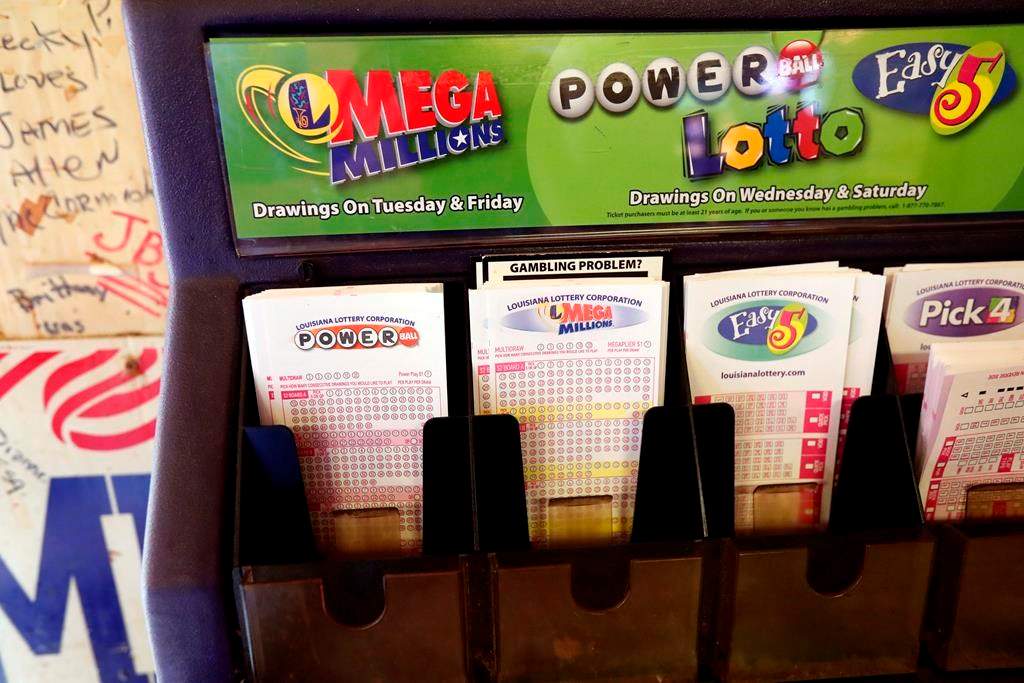 FILE - In this Tuesday, Oct. 23, 2018 file photo, lottery forms for Louisiana Mega Millions, Powerball and other lottery games fill the drawer at The World Bar and Grill, in Delta, La., a few miles from the Mississippi-Louisiana state line.