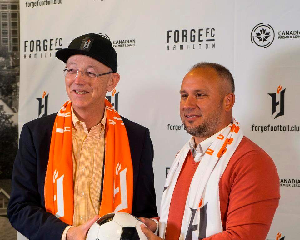 Forge FC has named Bobby Smyrniotis technical director and head coach of the Hamilton-based Canadian Premier League team. Forge FC team owner Bob Young, left, and head coach and technical director Bobby Smyrniotis pose during a press conference in Hamilton, Ont., in a Monday, Oct. 1, 2018, handout photo. THE CANADIAN PRESS/HO-Forge FC, Tyler Brown, *MANDATORY CREDIT*.