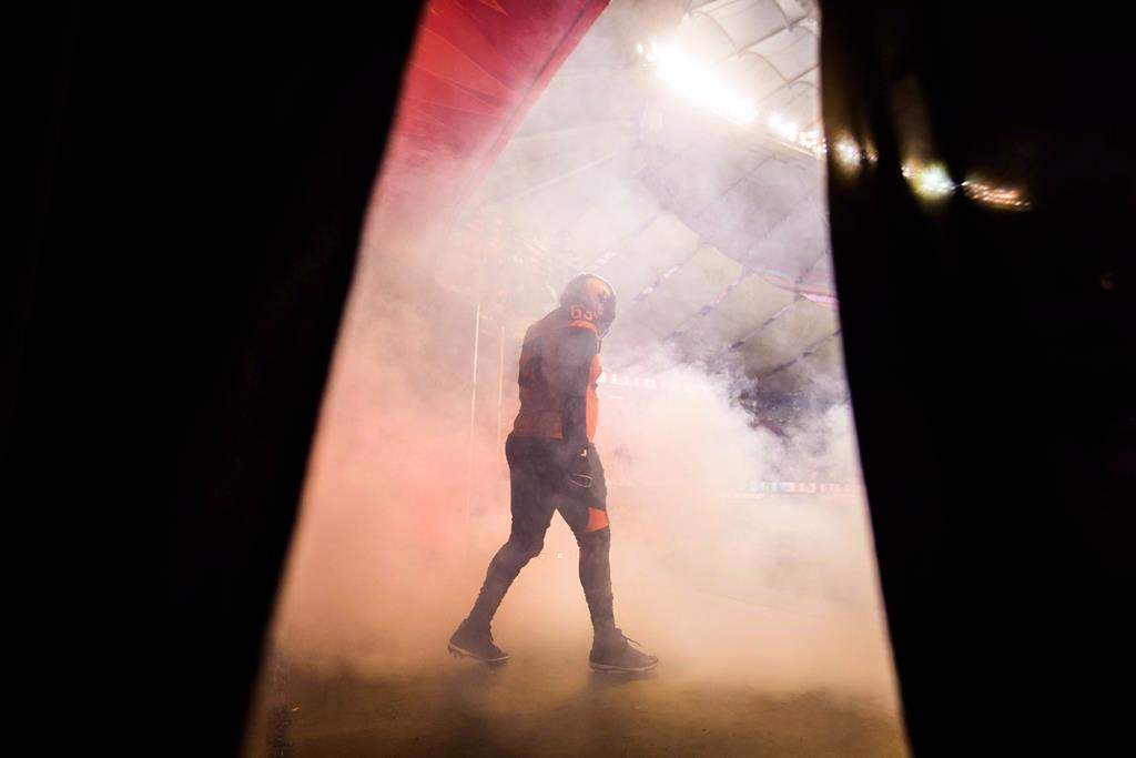 B.C. Lions offensive lineman Jovan Olafioye walks onto the field after being introduced before a CFL football game against the Hamilton Tiger-Cats in Vancouver on September 22, 2018.
