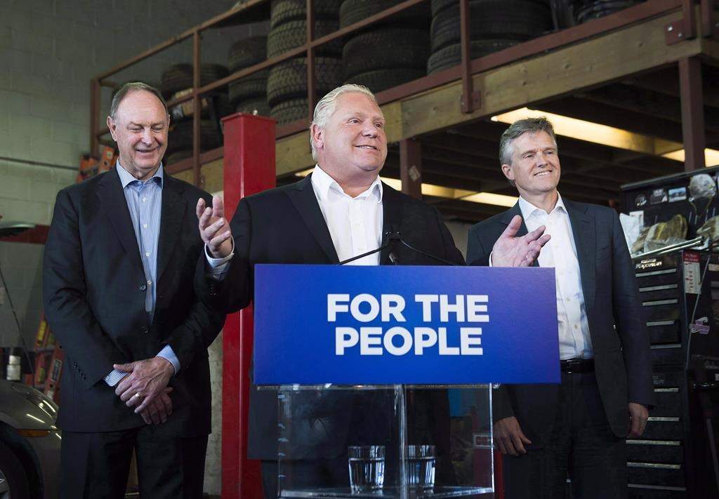Premier Doug Ford, centre, speaks to the media with Rod Phillips and John Yakabuski inToronto, on Friday, September 28, 2018.