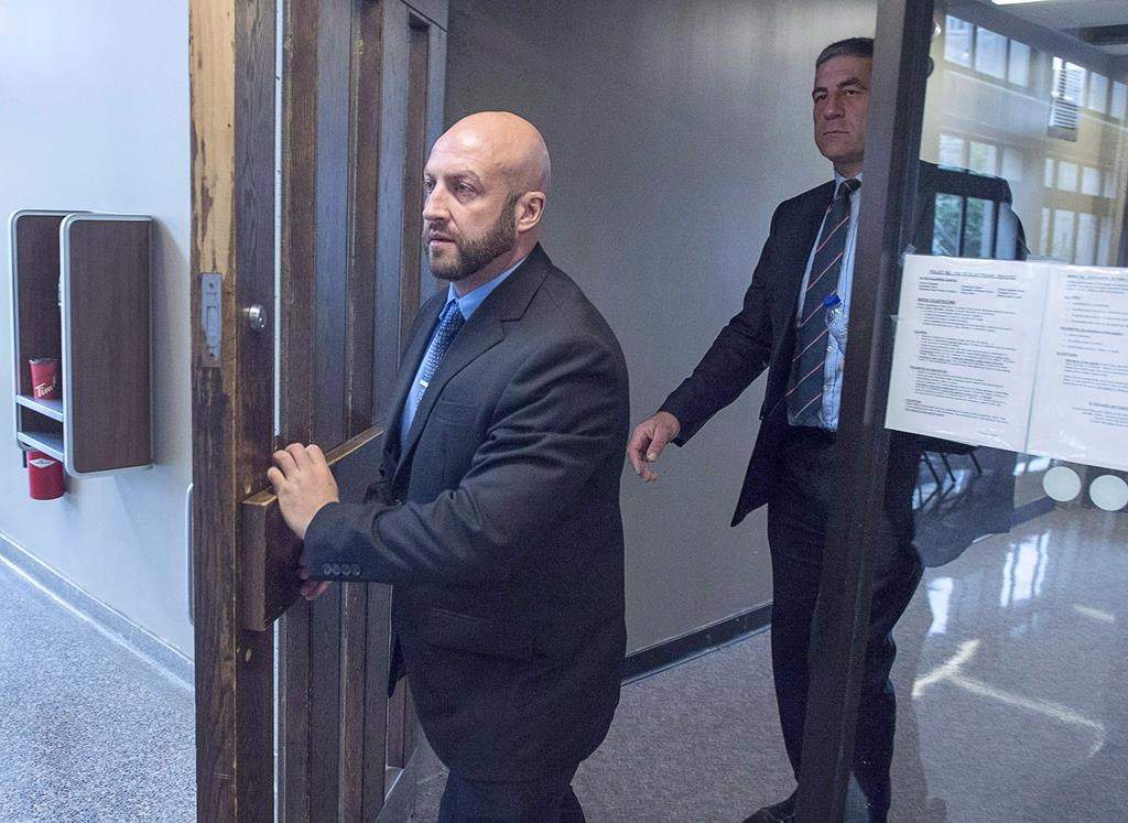 Darren Smalley, left, a British sailor charged with sexual assault causing bodily harm, heads from Supreme Court in Halifax on September 4, 2018. THE CANADIAN PRESS/Andrew Vaughan.