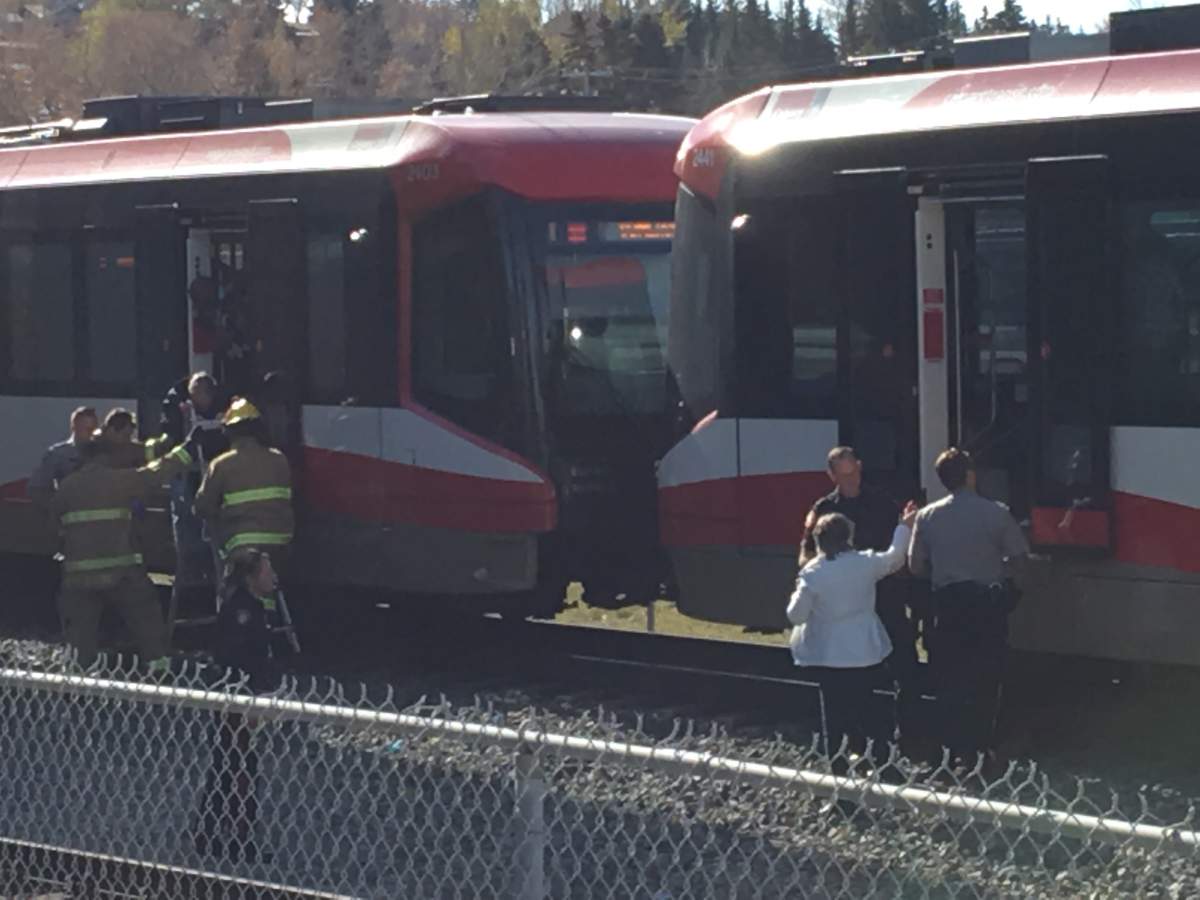 Passengers being removed from train cars after a CTrain collided with a pedestrian at the Erlton LRT Station on Monday, Oct. 15.