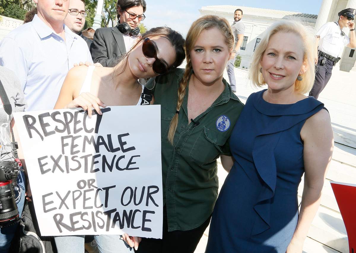 (L to R) Model and actress Emily Ratajkowski; actress and comedian Amy Schumer; and Sen. Kirsten Gillibrand (D-NY) join the Brett Kavanaugh U.S. Supreme Court Confirmation Protest in front of the Supreme Court on October 4, 2018 in Washington, DC. (Photo by Paul Morigi/WireImage)