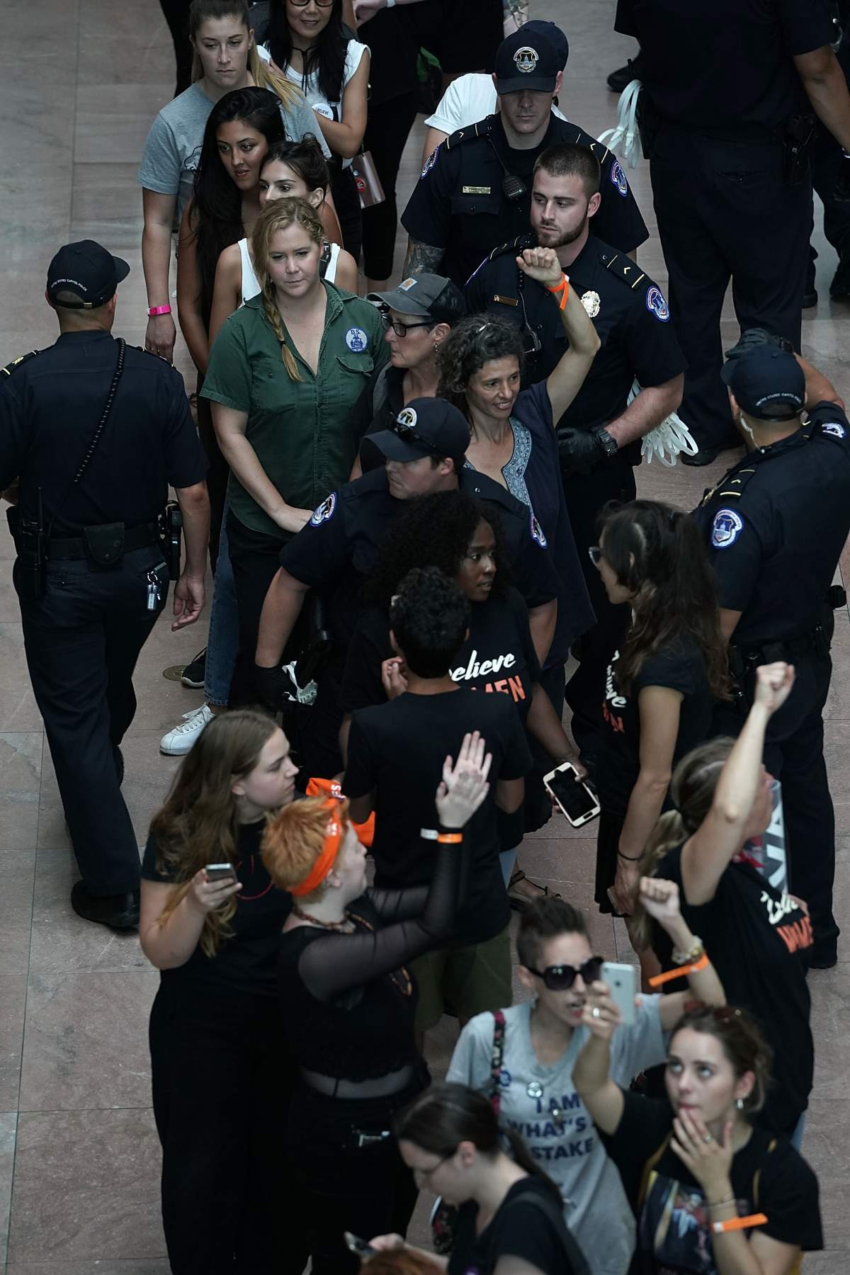 Comedian Amy Schumer, in green, is led away after she was arrested with other demonstrators during a protest against the confirmation of Supreme Court nominee Judge Brett Kavanaugh Oct. 4, 2018. (Photo by Alex Wong/Getty Images)
