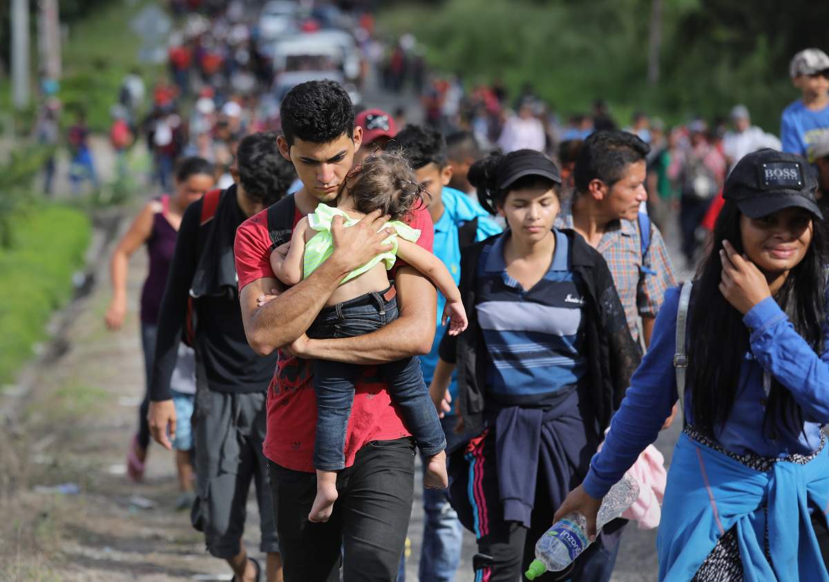 A caravan of more than 1,500 Honduran migrants moves north after crossing the border from Honduras into Guatemala on October 15, 2018, in Esquipulas, Guatemala.