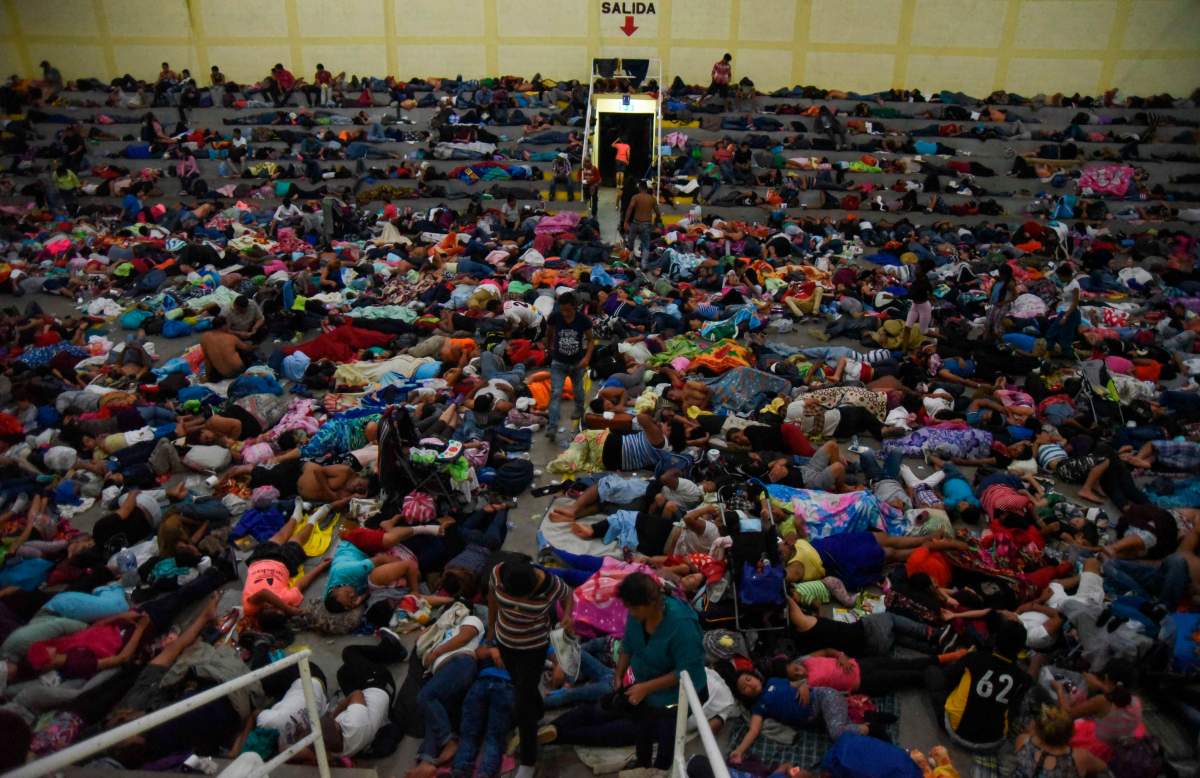 Honduran migrants heading to the United States, rest at a gymnasium of a Catholic church in Chiquimula, Guatemala, on October 16, 2018.