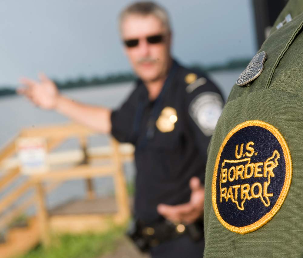 Supervisor Dan Moore of the Customs and Border Patrol agency speaks with Supervisor Richard Labounty of the US Border Patrol at a dock facility on Lake Champlain. 