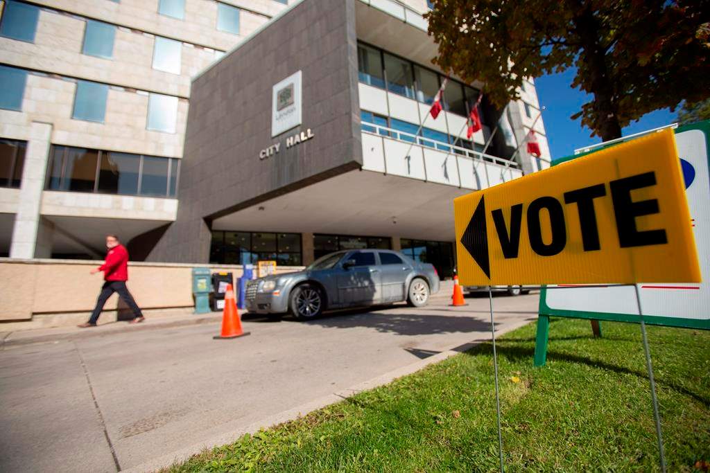A sign points voters towards a polling station at City Hall in London, Ont., on Monday, October 22, 2018. London is the first municipality to adopt a ranked ballot system in Canada. THE CANADIAN PRESS/Geoff Robins.