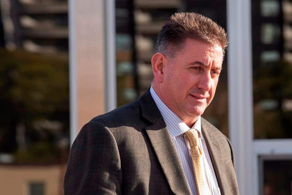 Former gymnastics coach Dave Brubaker, right, leaves the court house in Sarnia, Ont., Tuesday, October 23, 2018 following the first day of testimony in his sexual assault trial.