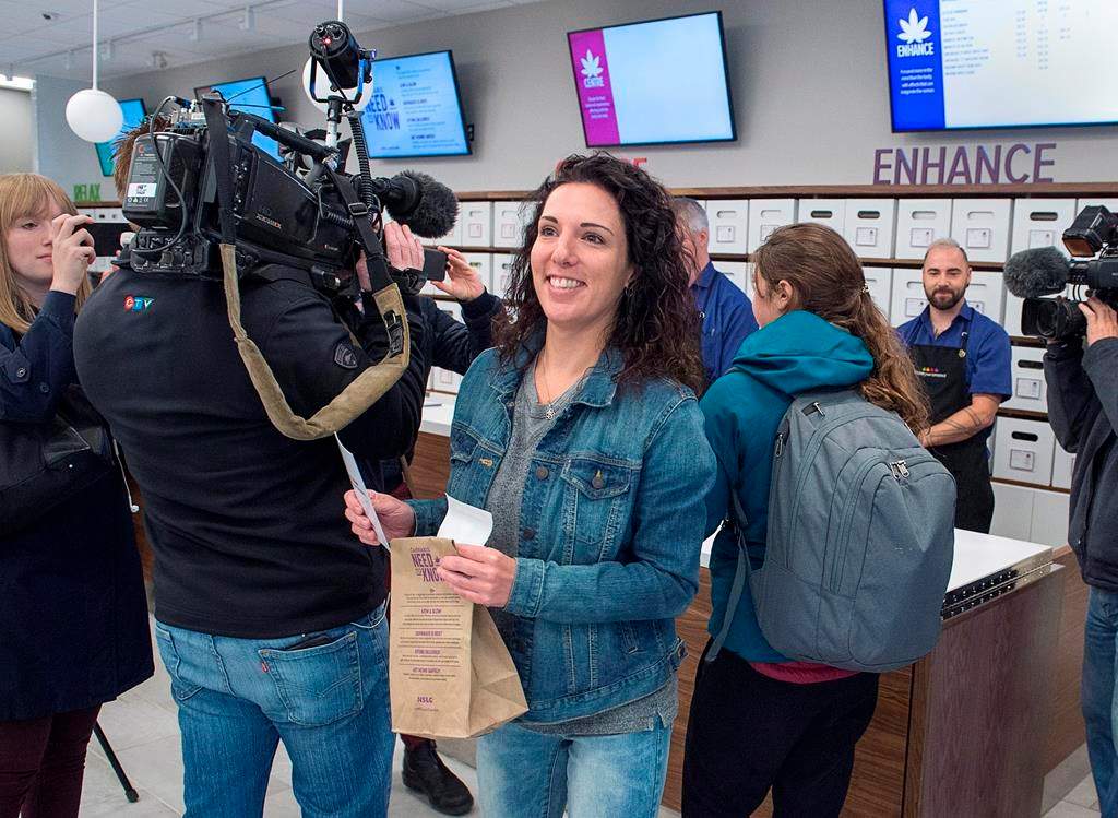 Alicia Wright heads from the counter after making the first purchase at the Nova Scotia Liquor Corporation cannabis story in Halifax on Oct. 17, 2018. Residents can make their purchases at 12 Nova Scotia Liquor Corporation stores across the province and online. THE CANADIAN PRESS/Andrew Vaughan