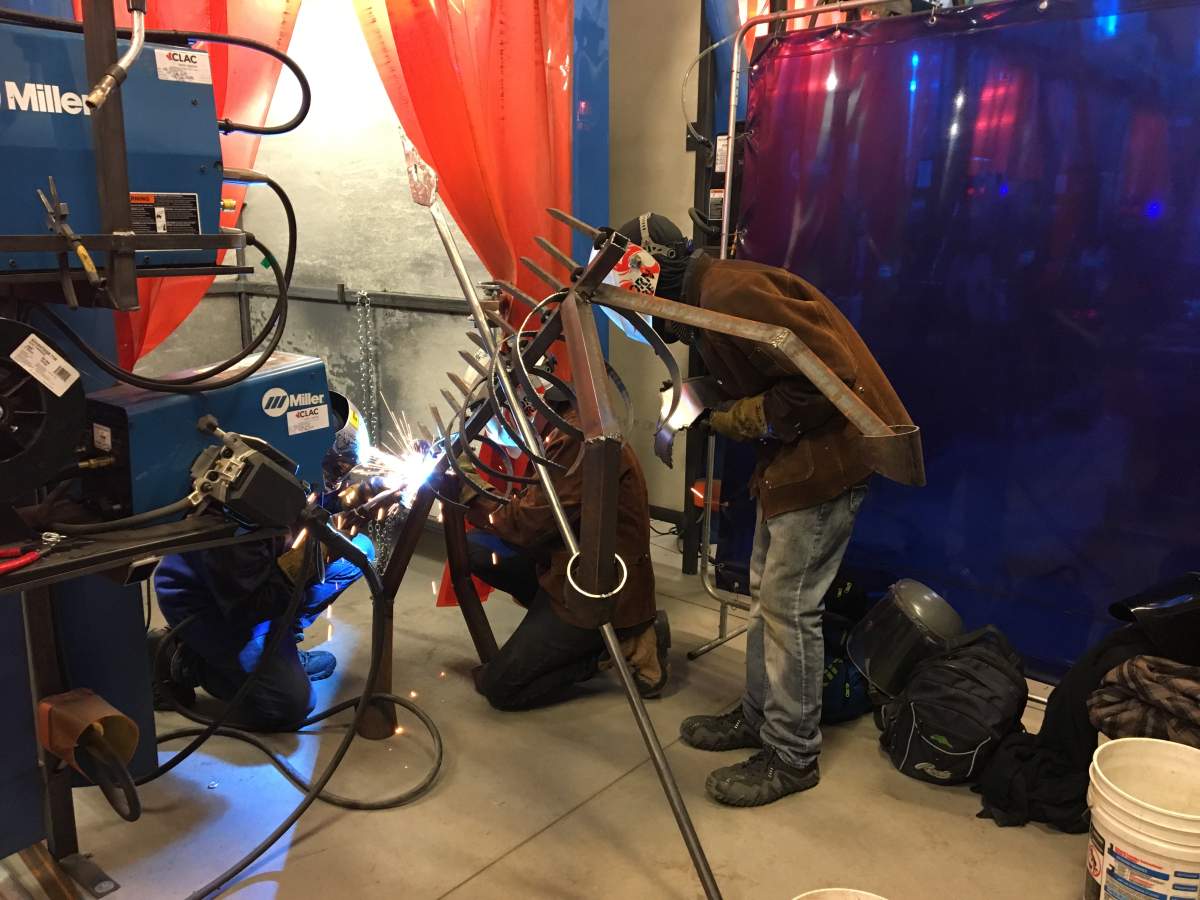 Edmonton-area students weld a metallic, Halloween-themed creature on Saturday, Oct. 20, 2018.