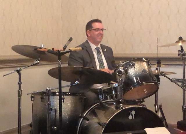 Cam Guthrie celebrates by playing the drums after being re-elected for a second term as mayor of Guelph.