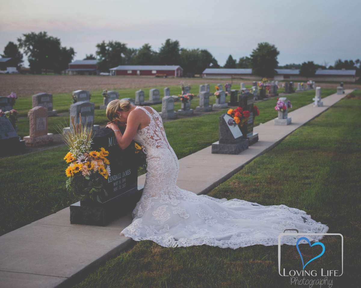 Jessica Padgett kneels at the grave of her fiance Kendall Murphy on Sept. 29, 2018.