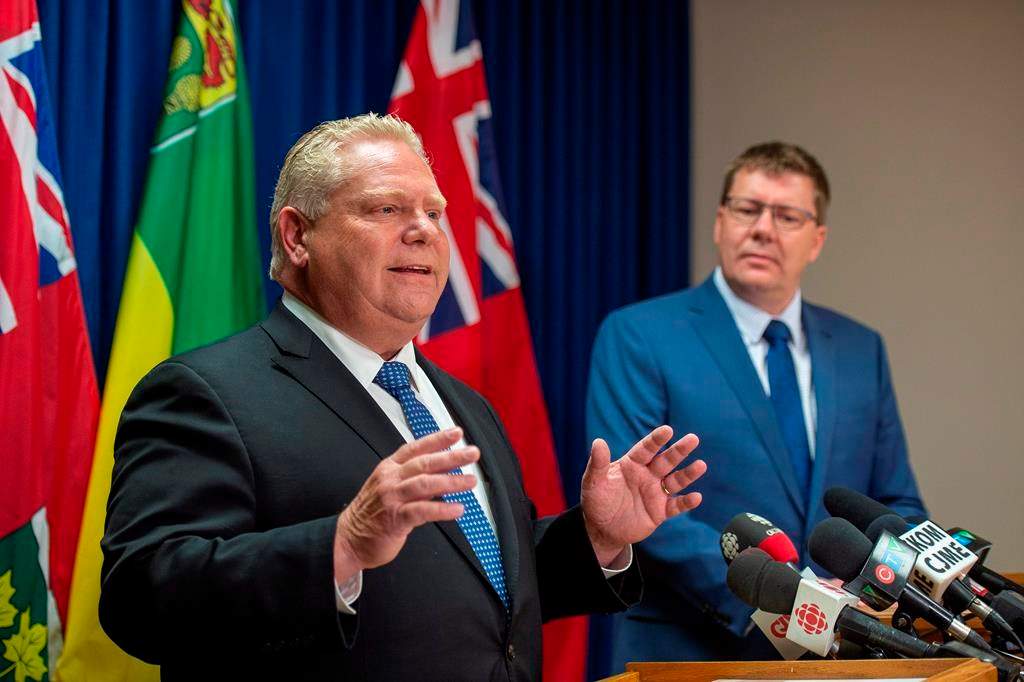 Premier of Ontario Doug Ford, left, speaks as Premier of Saskatchewan Scott Moe listens during a media event in Saskatoon, Thursday, October 4, 2018.