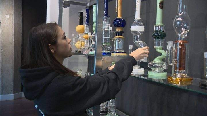 Cierra Sieben-Chuback stocks shelves at her store, Living Skies Cannabis in Saskatoon.