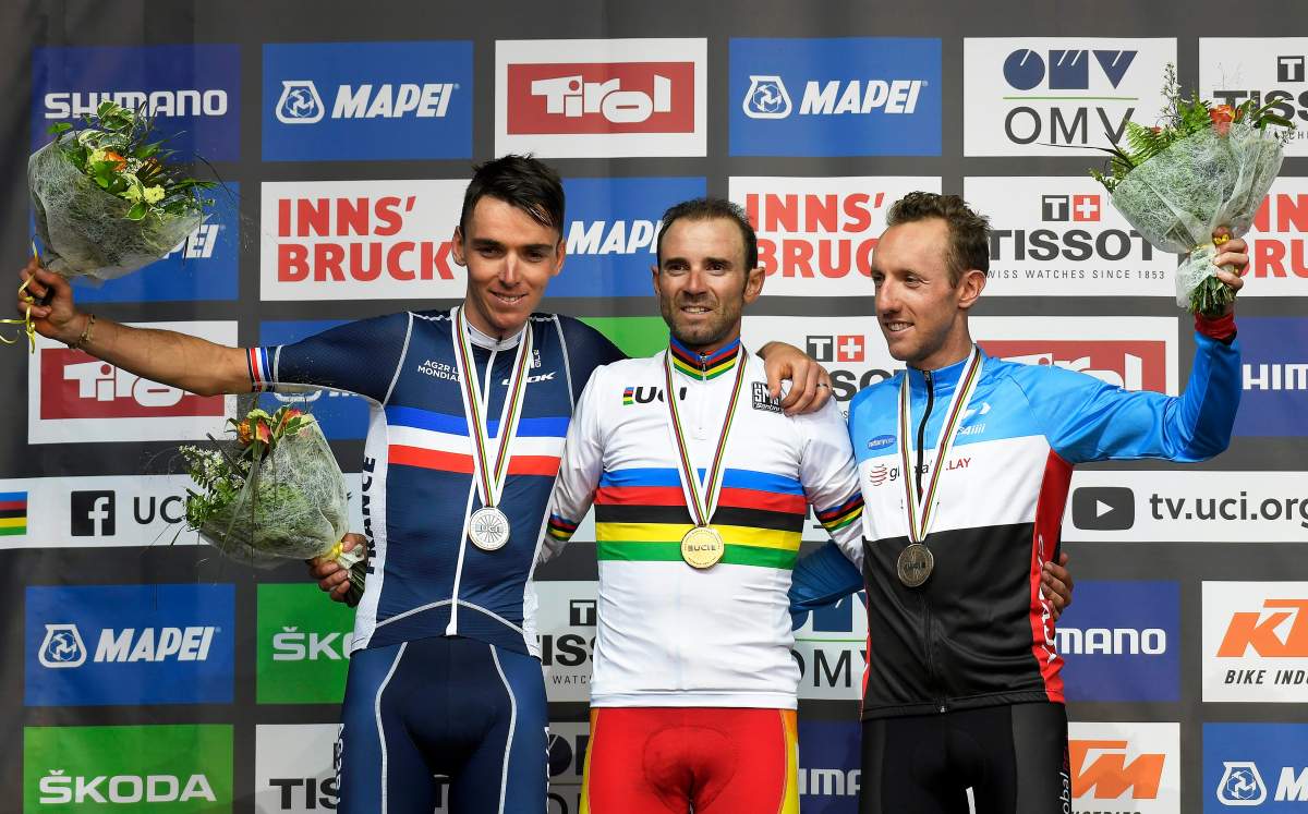 Alejandro Valverde (C) of Spain poses with his gold medal on the podium after winning the men's Elite Road Race of the UCI Road Cycling World Championships over 258km from Kufstein to Innsbruck, Austria, 30 September 2018. Valverde won ahead of second placed Romain Bardet (L) of France and third placed Michael Woods (R) of Canada.
