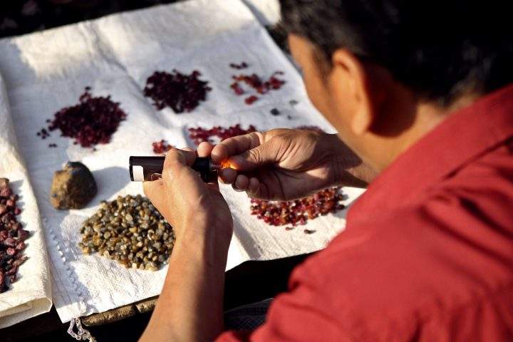 A man checks an uncut ruby at the gems market in Mogok, about 200 km north of Mandalay, Mandalay division, Myanmar, April 11, 2016.