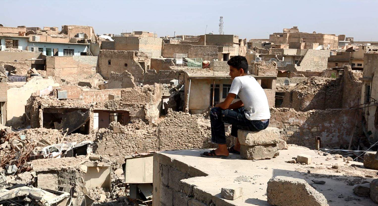 A young Iraqi over looks the city of Mosul.