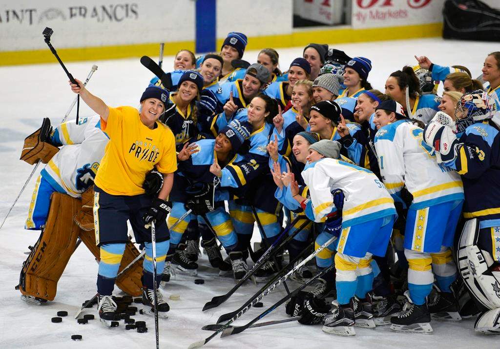 FILE - In this Jan. 24, 2016, file photo, National Women's Hockey League All-Star players take time for a "selfie" before the start of an all-star game at Harborcenter in Buffalo, N.Y.