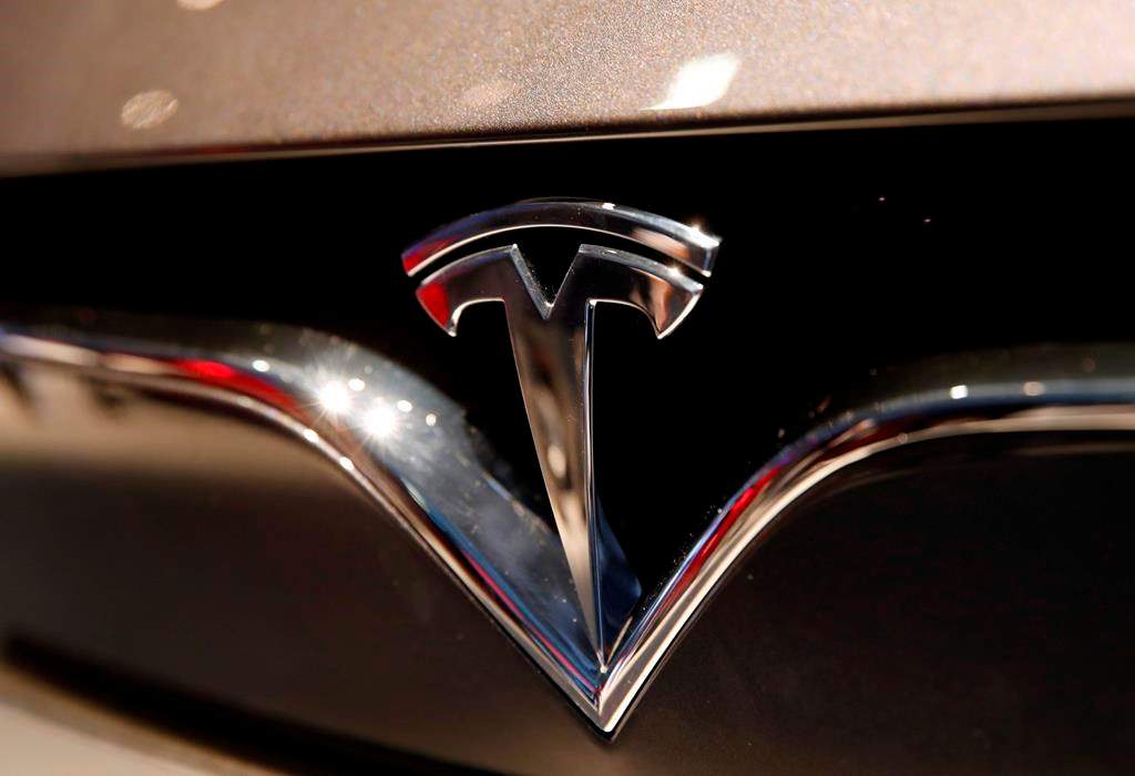 This Oct. 3, 2018, file photo shows a Tesla emblem at the Auto show in Paris.