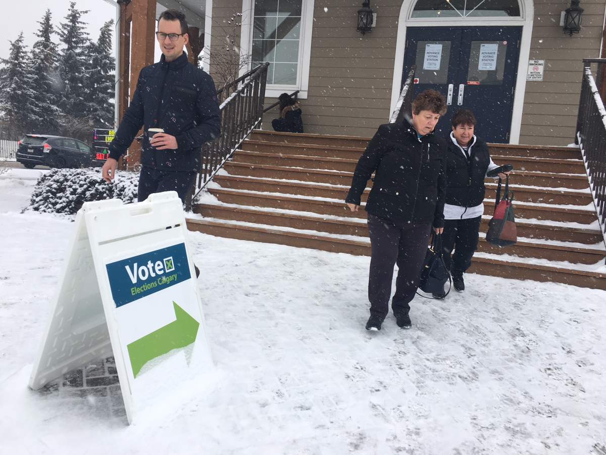 People exit a polling station in Calgary, Alta. for the advance voting for the 2026 Olympic bid plebiscite on Nov. 6, 2018.