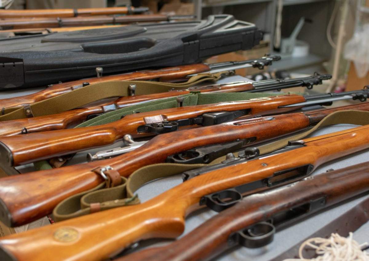 Police found over two dozen rifles and thousands of rounds of ammo in the home.
