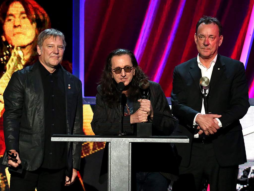 (L-R) Alex Lifeson, Geddy Lee and Neil Peart of Rush onstage during the 28th Annual Rock and Roll Hall of Fame Induction Ceremony at Nokia Theatre, on April 18, 2013 in Los Angeles, Calif. 