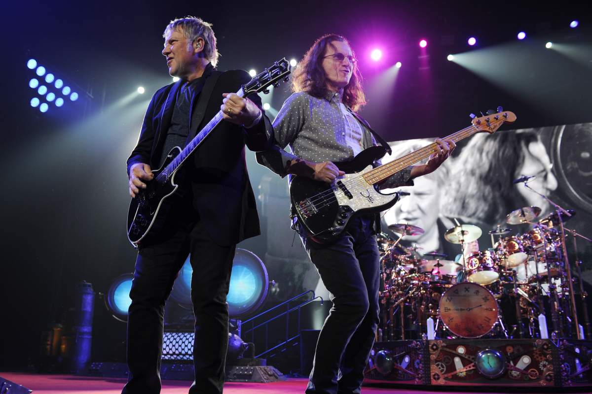 (L-R) Alex Lifeson, Geddy Lee and Neil Peart (behind the drums) of Rush perform at BB&T Center on April 26, 2013 in Sunrise, Flor.